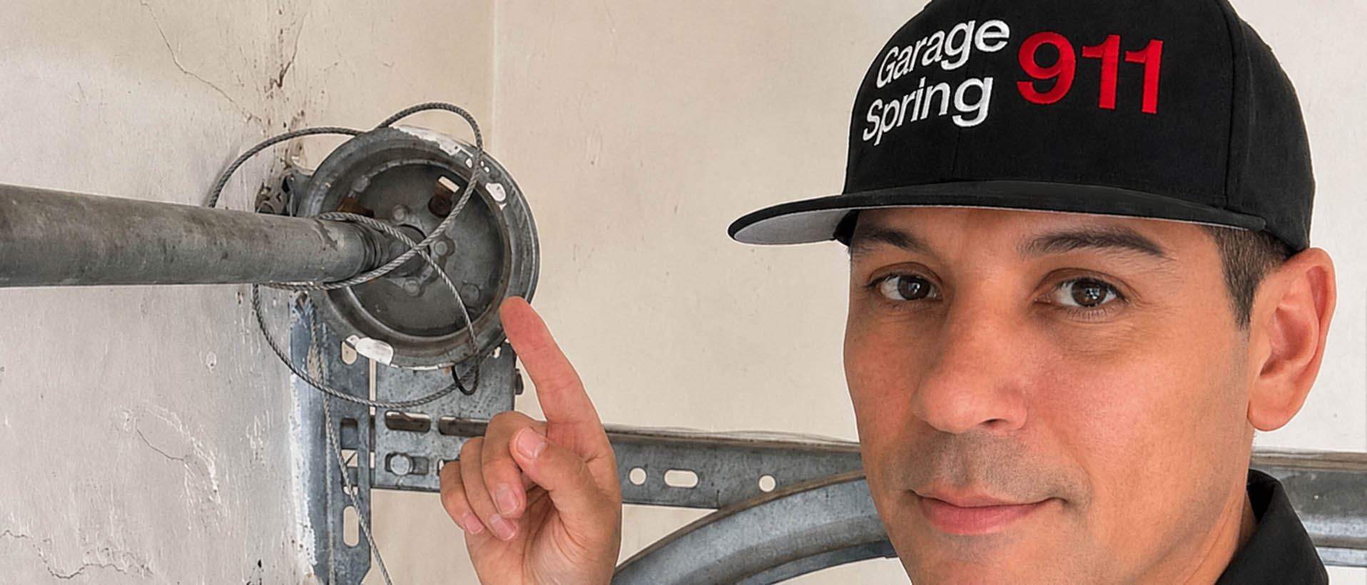 Garage door repair technician replacing a broken cable in San Diego CA.